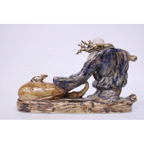 398 - A CHINESE PORCELAIN BUDDHA PULLING A SACK WITH RATS