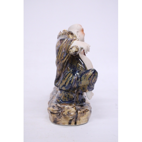 398 - A CHINESE PORCELAIN BUDDHA PULLING A SACK WITH RATS