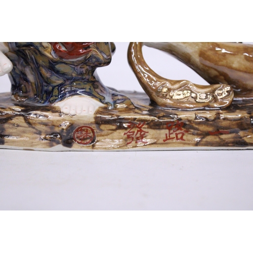 398 - A CHINESE PORCELAIN BUDDHA PULLING A SACK WITH RATS