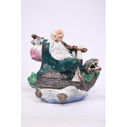 400 - A CHINESE PORCELAIN WISE MAN RIDING A DRAGON TURTLE