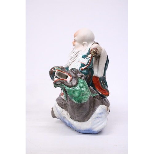 400 - A CHINESE PORCELAIN WISE MAN RIDING A DRAGON TURTLE