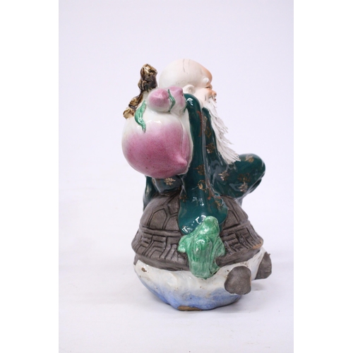 400 - A CHINESE PORCELAIN WISE MAN RIDING A DRAGON TURTLE