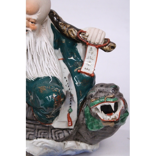 400 - A CHINESE PORCELAIN WISE MAN RIDING A DRAGON TURTLE