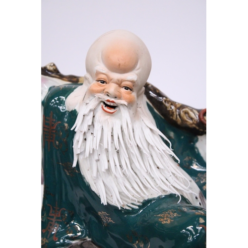 400 - A CHINESE PORCELAIN WISE MAN RIDING A DRAGON TURTLE