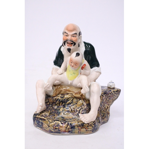 402 - A CHINESE PORCELAIN MAN WITH BABY