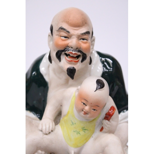 402 - A CHINESE PORCELAIN MAN WITH BABY