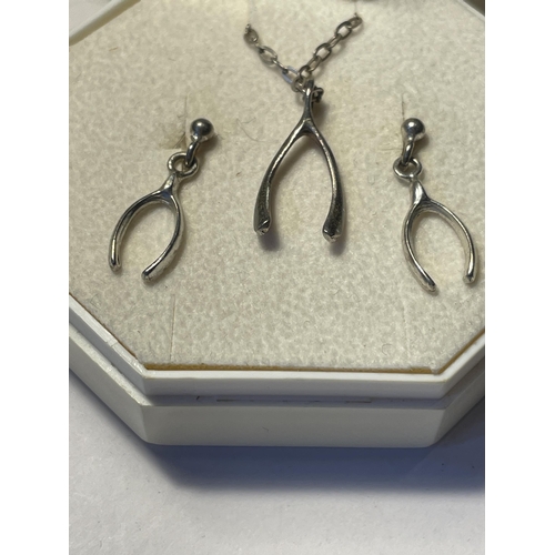 602 - A SILVER WISHBONE NECKLACE AND EARRINGS SET IN A PRESENTATION BOX