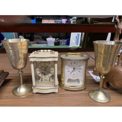 1285 - TWO CARRIAGE CLOCKS, A PAIR OF BRASS GOBLETS AND PLATE, A CAT FIGURE, ETC