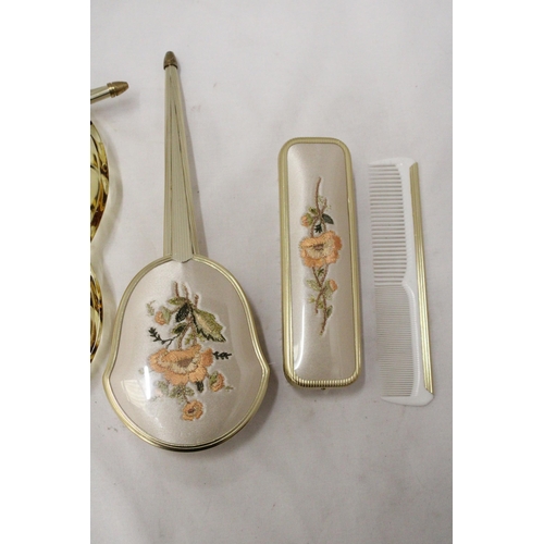 285 - A VINTAGE DRESSING TABLE BRUSH TO INCLUDE, GLAS TRAY, TWO BRUSHES, A MIRROR AND COMB, WITH EMBROIDER... 