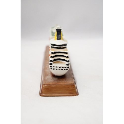 291 - A HEAVY SOLID OCEAN LINER ON WOODEN STAND (ARTEMIS), LENGTH 26CM, HEIGHT 6CM