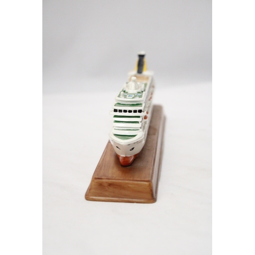 291 - A HEAVY SOLID OCEAN LINER ON WOODEN STAND (ARTEMIS), LENGTH 26CM, HEIGHT 6CM