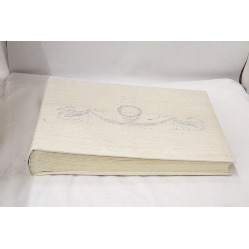 299 - A LARGE PHOTOGRAPH ALBUM WITH AN EMBROIDERED SILK COVER