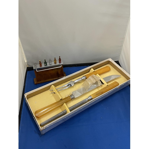 19 - TWO VINTAGE ITEMS TO INCLUDE BOXED CARVING SET AND A BAR CONTAINING NOVELTY COCKTAIL STICKS