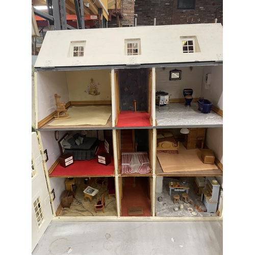 40A - A VINTAGE THREE STOREY DOLLS HOUSE WITH FURNITURE AND LIGHTS