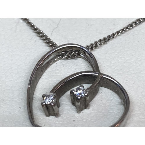 518 - A WHITE ICE SILVER AND DIAMOND NECKLACE WITH HEART PENDANT CONTAINING TWO DIAMONDS IN AN ORIGINAL PR... 