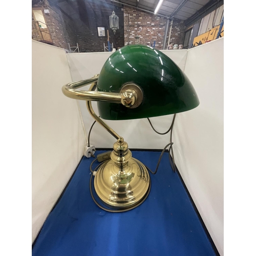 69 - A BRASS BANKERS LAMP WITH A GREEN GLASS SHADE