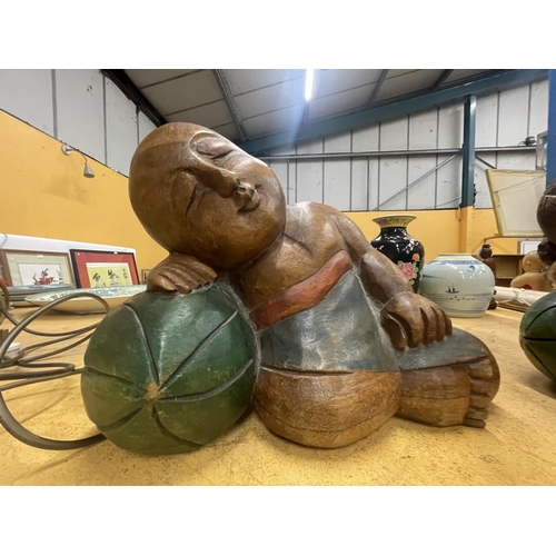 70 - TWO LARGE CARVED HARDWOOD ORIENTAL FIGURES OF A SLEEPING BOY AND GIRL APPROXIMATELY 22CM TALL