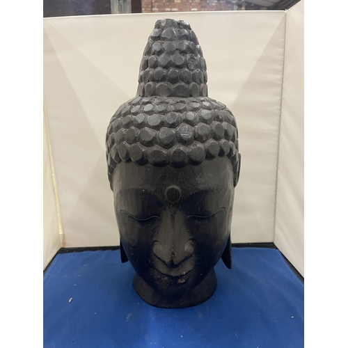 72 - A LARGE CARVED BUDDHA HEAD 34CM TALL