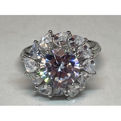 511 - A WHITE METAL RING WITH 3 CARATS OF MOISSANITE STONES IN A FLOWER DESIGN AND ON THE SHOULDERS SIZE N