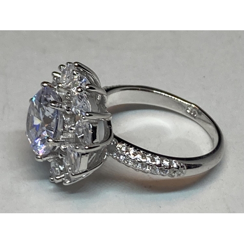 511 - A WHITE METAL RING WITH 3 CARATS OF MOISSANITE STONES IN A FLOWER DESIGN AND ON THE SHOULDERS SIZE N