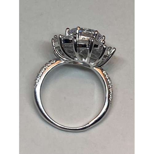 511 - A WHITE METAL RING WITH 3 CARATS OF MOISSANITE STONES IN A FLOWER DESIGN AND ON THE SHOULDERS SIZE N