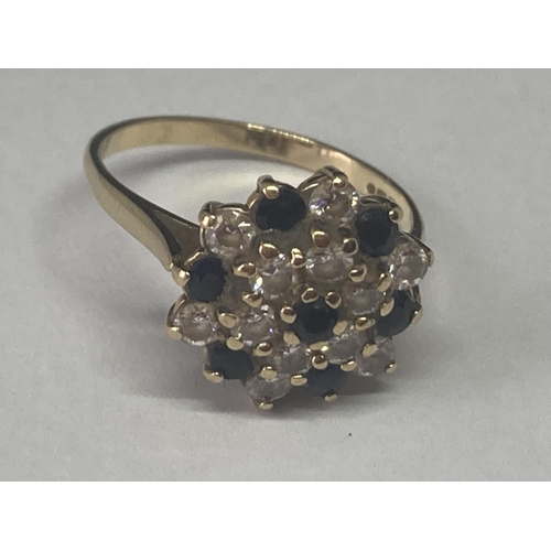 520 - A 9 CARAT GOLD RING WITH SAPPHIRE AND CUBIC ZIRCONIAS IN A CLUSTER DESIGN SIZE M/N