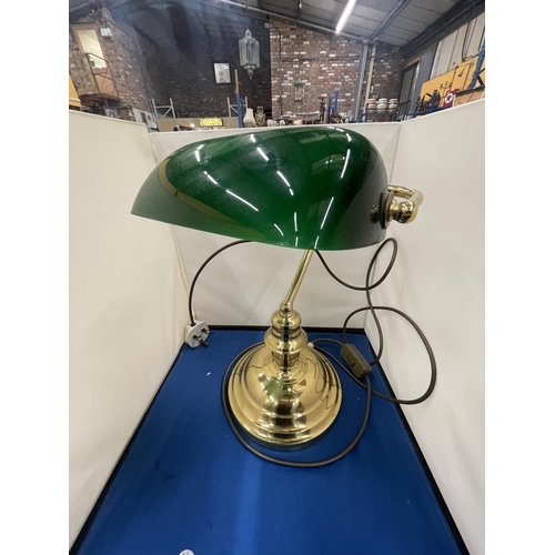 69 - A BRASS BANKERS LAMP WITH A GREEN GLASS SHADE