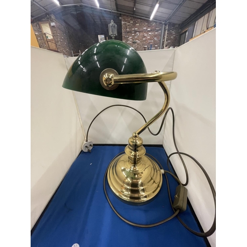 69 - A BRASS BANKERS LAMP WITH A GREEN GLASS SHADE