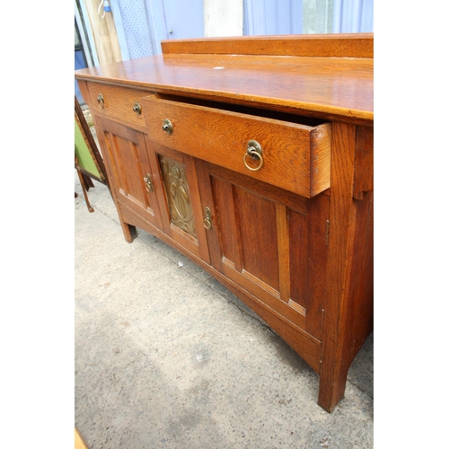 3132 - AN ART NOUVEAU OAK SIDEBOARD WITH CENTRAL EMBOSSED COPPER PANEL - 66