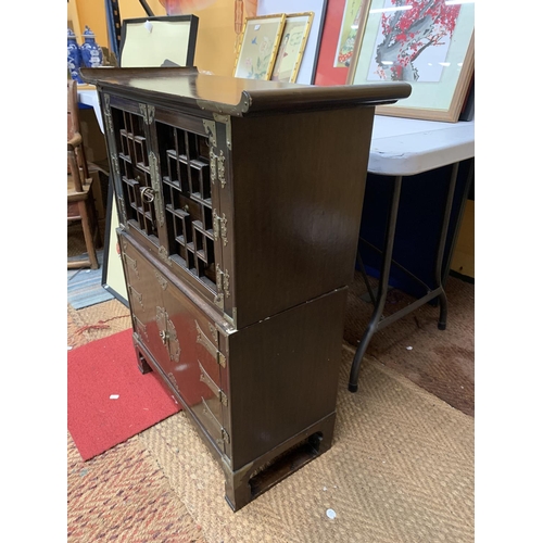 440 - A KOREAN WOOD AND BRASS APOTHECARY CABINET, REVEALING 14 DRAWERS, STACKED ON A HINGED DOOR COMPARTME... 