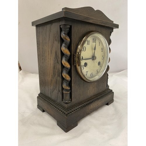 136 - A WOODEN MANTLE CLOCK WITH BARLEY TWIST DESIGN