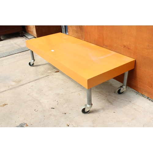 3023 - A MODERN COFFEE TABLE ON CASTERS, 49