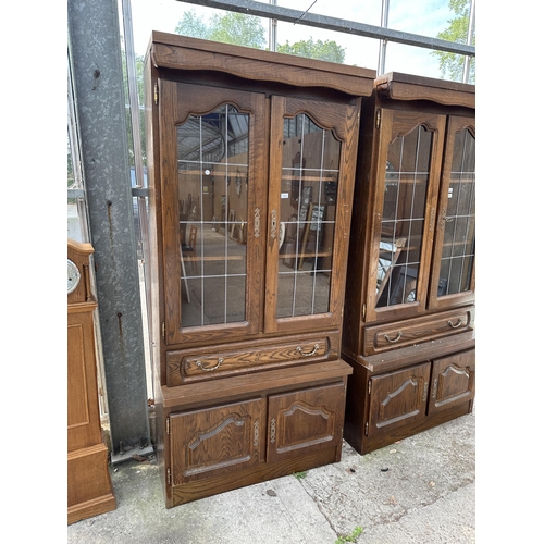 3063 - AN OAK CABINET WITH GLAZED AND LEADED UPPER PORTION, 37