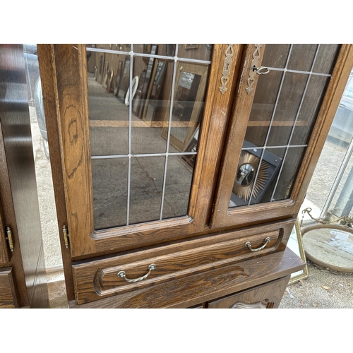 3064 - AN OAK CABINET WITH GLAZED AND LEADED UPPER PORTION, 37