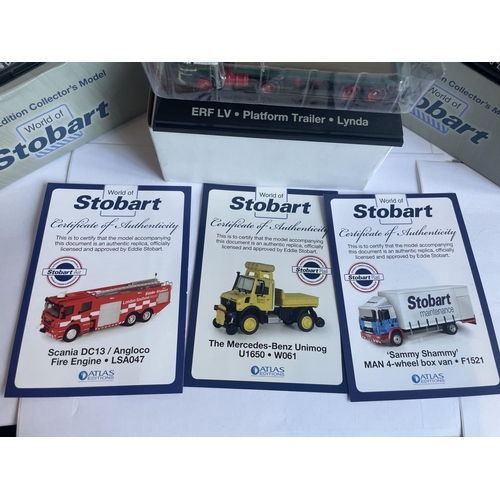 381 - FOUR BOXED STOBART VEHICLES TO INCLUDE A UNIMOG, FIRE ENGINE AND TWO WAGONS THREE WITH COA