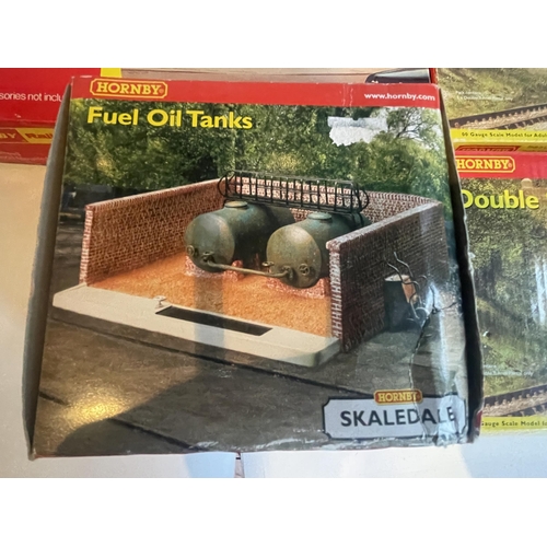 422 - FIVE BOXED HORNBY MODELS TO INCLUDE FUEL OIL TANKS, DOUBLE STONE TUNNEL PORTALS, A DIESEL MAINTENANC... 