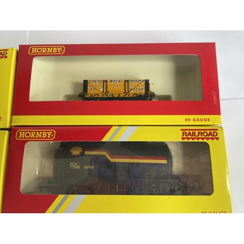 438 - FOUR BOXED HORNBY 00 GAUGE FREIGHT CARRIAGES TO INCLUDE THREE SHELL TANKERS AND A PLANK WAGON