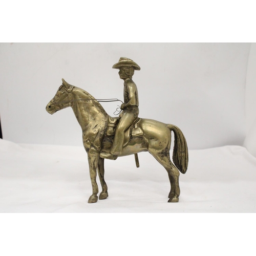 112 - AN UNUSUAL SOLID BRASS COWBOY AND HORSE - APPROXIMATELY 22CM X 22CM - WEIGHS OVER TWO KILO