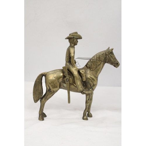 112 - AN UNUSUAL SOLID BRASS COWBOY AND HORSE - APPROXIMATELY 22CM X 22CM - WEIGHS OVER TWO KILO