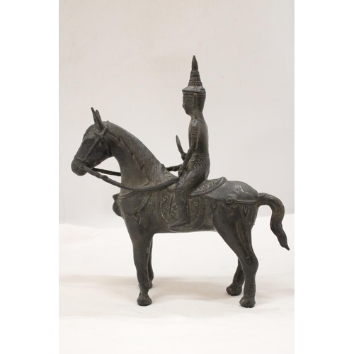 142 - AN ORIENTAL BRONZE HORSE AND WARRIOR RIDER, HEIGHT 25CM, LENGTH 23CM