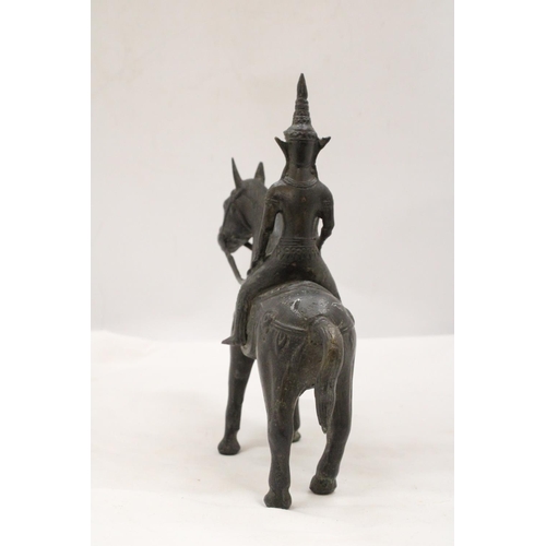 142 - AN ORIENTAL BRONZE HORSE AND WARRIOR RIDER, HEIGHT 25CM, LENGTH 23CM