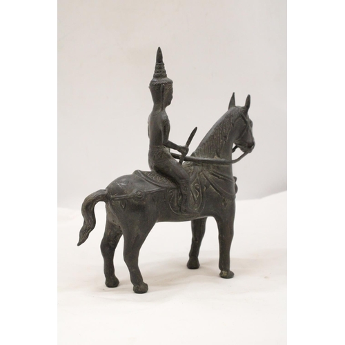 142 - AN ORIENTAL BRONZE HORSE AND WARRIOR RIDER, HEIGHT 25CM, LENGTH 23CM