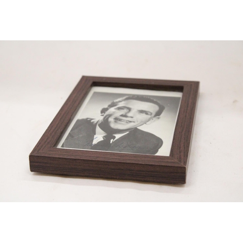 150 - A SIGNED AND FRAMED NORMAN WISDOM PHOTOGRAPH