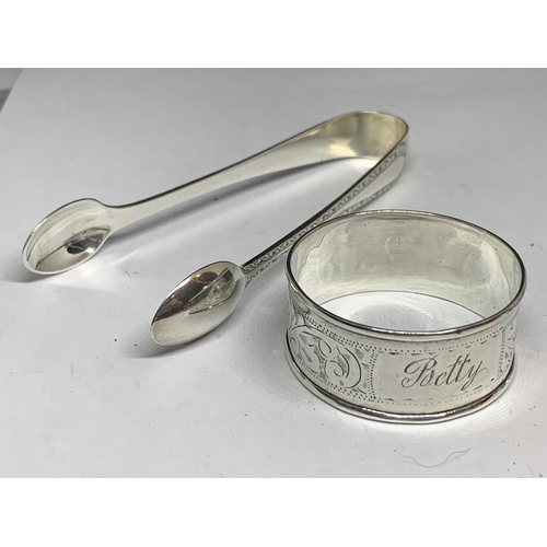 32 - FOUR HALLMARKED SILVER ITEMS TO INCLUDE SHEFFIELD SUGAR NIPS AND THREE NAPKINS RINGS ONE BIRMINGHAM,... 