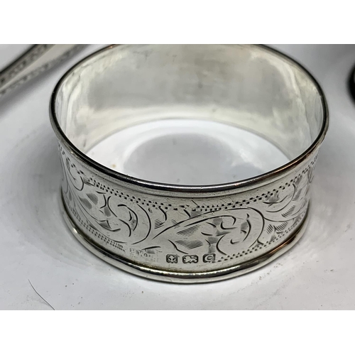 32 - FOUR HALLMARKED SILVER ITEMS TO INCLUDE SHEFFIELD SUGAR NIPS AND THREE NAPKINS RINGS ONE BIRMINGHAM,... 