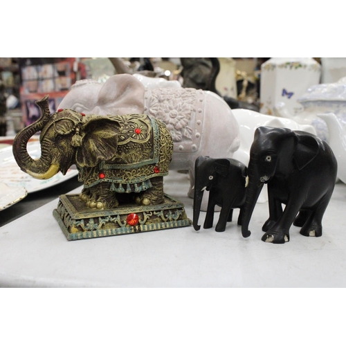 219 - A COLLECTION OF ELEVEN ELEPHANT FIGURES INCLUDING WOODEN AND CERAMIC