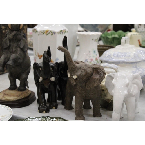 219 - A COLLECTION OF ELEVEN ELEPHANT FIGURES INCLUDING WOODEN AND CERAMIC