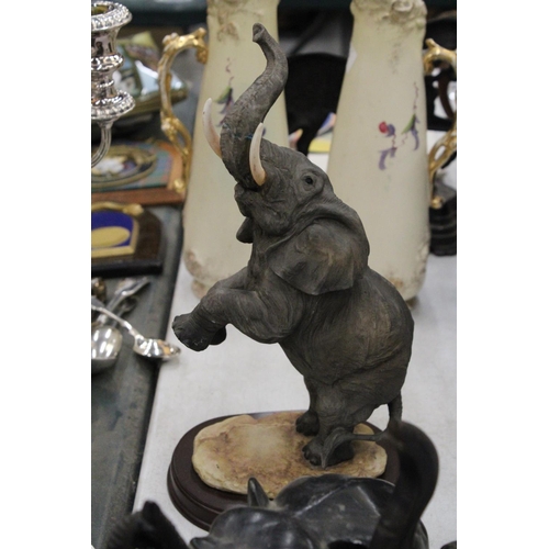 219 - A COLLECTION OF ELEVEN ELEPHANT FIGURES INCLUDING WOODEN AND CERAMIC