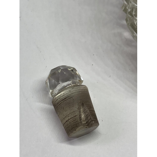 97 - A CUT GLASS BOTTLE WITH A HALLMARKED BIRMINGHAM SILVER TOP