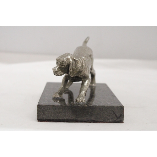 16 - A WHITE METAL DOG ON A MARBLE STAND